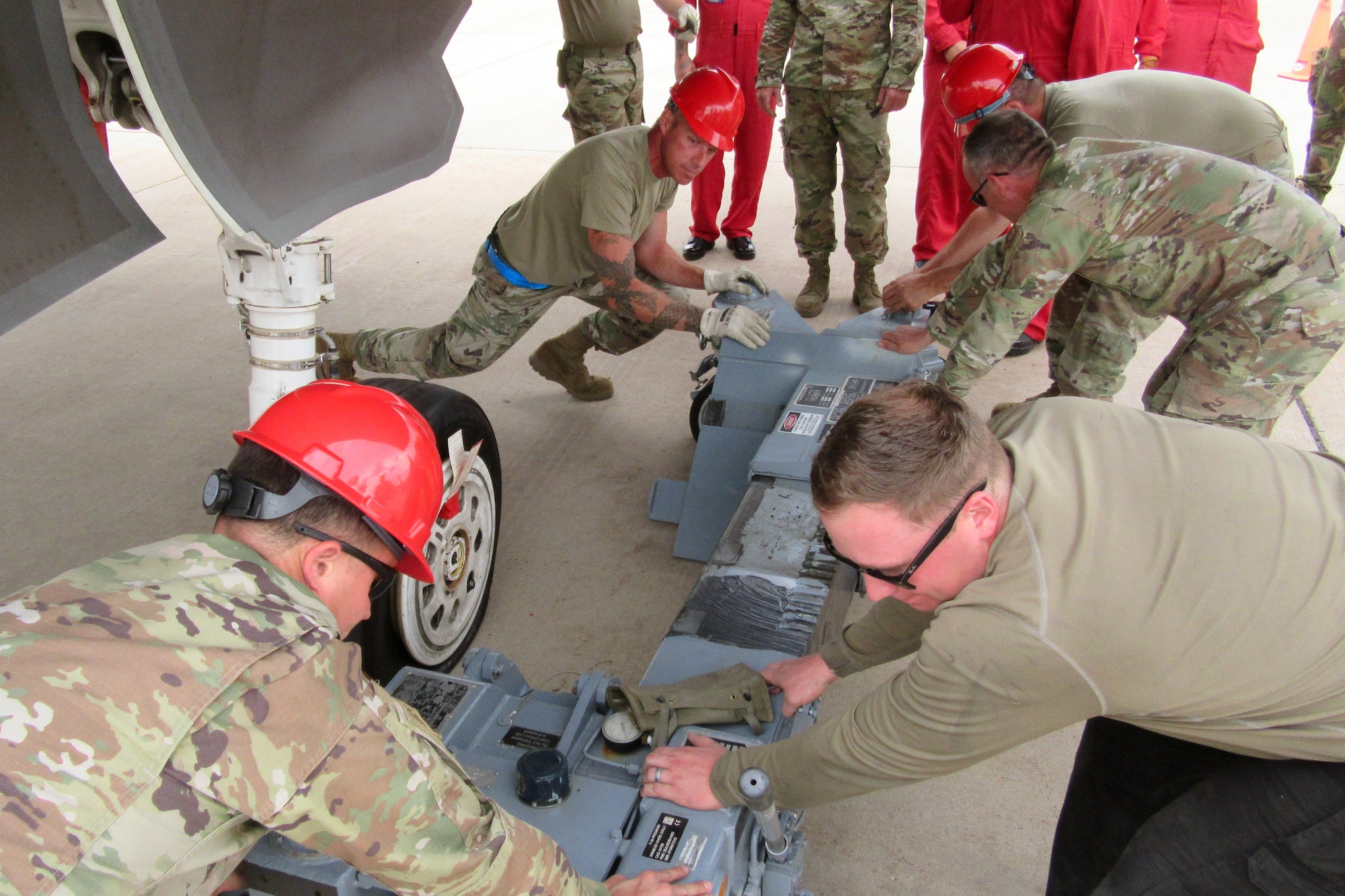 Students push a piece of equipment into position.