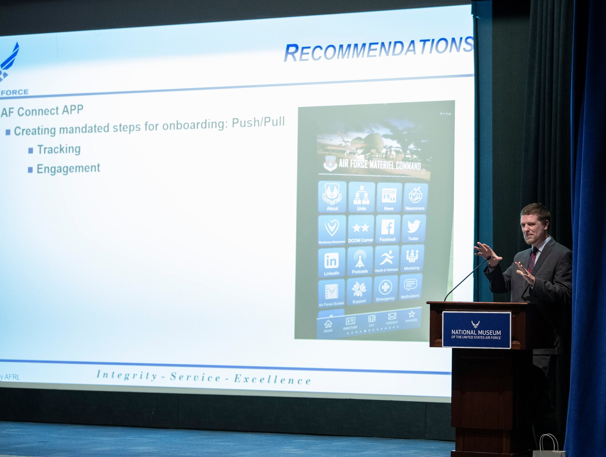 Program graduate presents his team's capstone to a panel of judges and classmates.