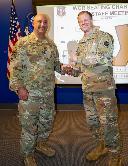 U.S. Air Force Col. Garry “Pink” Floyd, Director of the DAF-MIT Artificial Intelligence Accelerator, recognizes Capt. Timothy “Growler” Cullipher for going above and beyond to bring emerging AI capabilities to the field. Cullipher received the first ever AIA Top Stakeholder Award. (U.S. Air Force courtesy photo Capt. Victor Lopez)