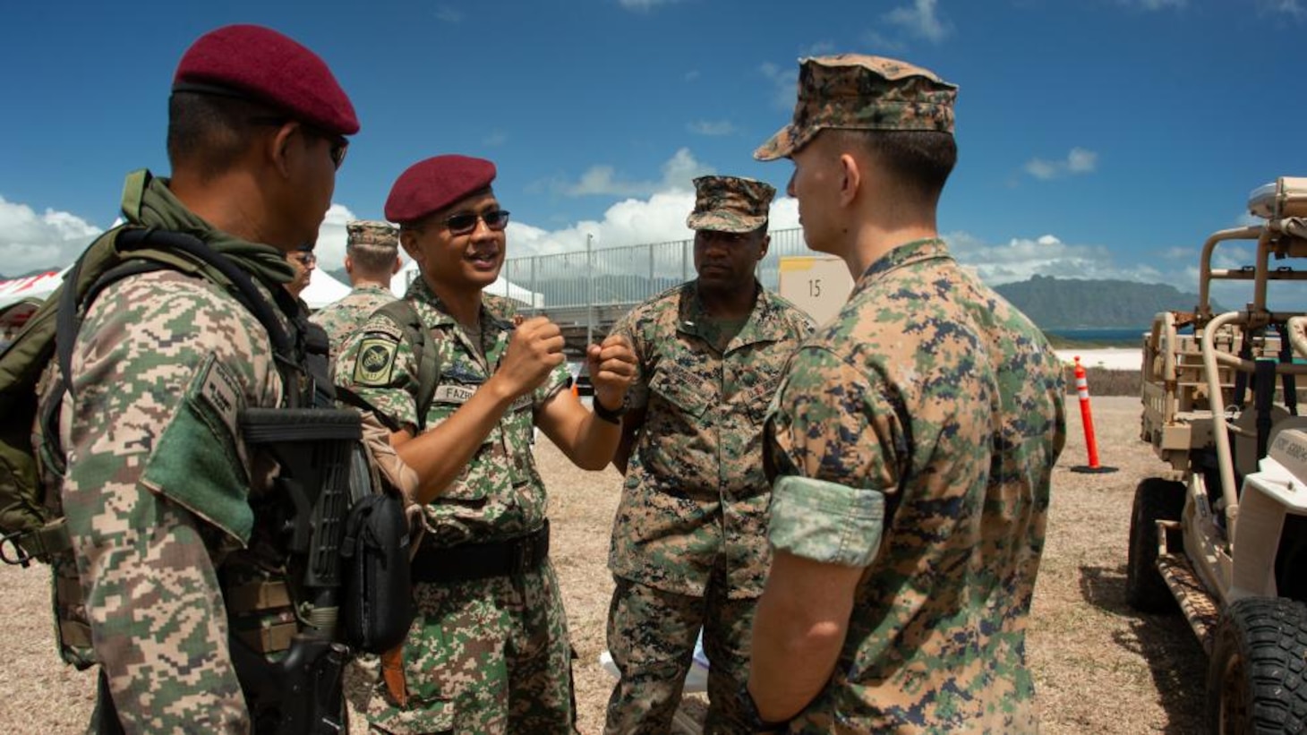 U.S. Marines with 3d Marine Littoral Regiment, 3d Marine Division, interact with Malaysian Army soldiers during Distinguished Visitor Day as part of the Rim of the Pacific (RIMPAC) 2022, August 1, 2022.