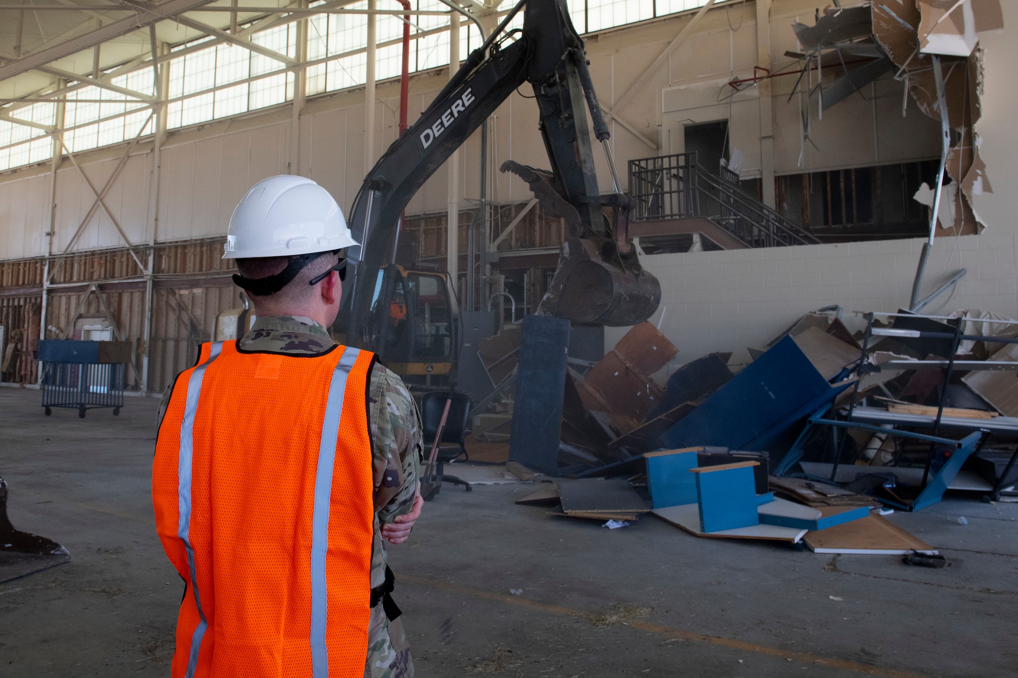 U.S. Air Force 1st Lt. Dan White, 325th Contracting Squadron contracting officer, observes a wall being taken down during the demolition of Hangar 3 at Tyndall Air Force Base, Florida, Sept. 20, 2022.