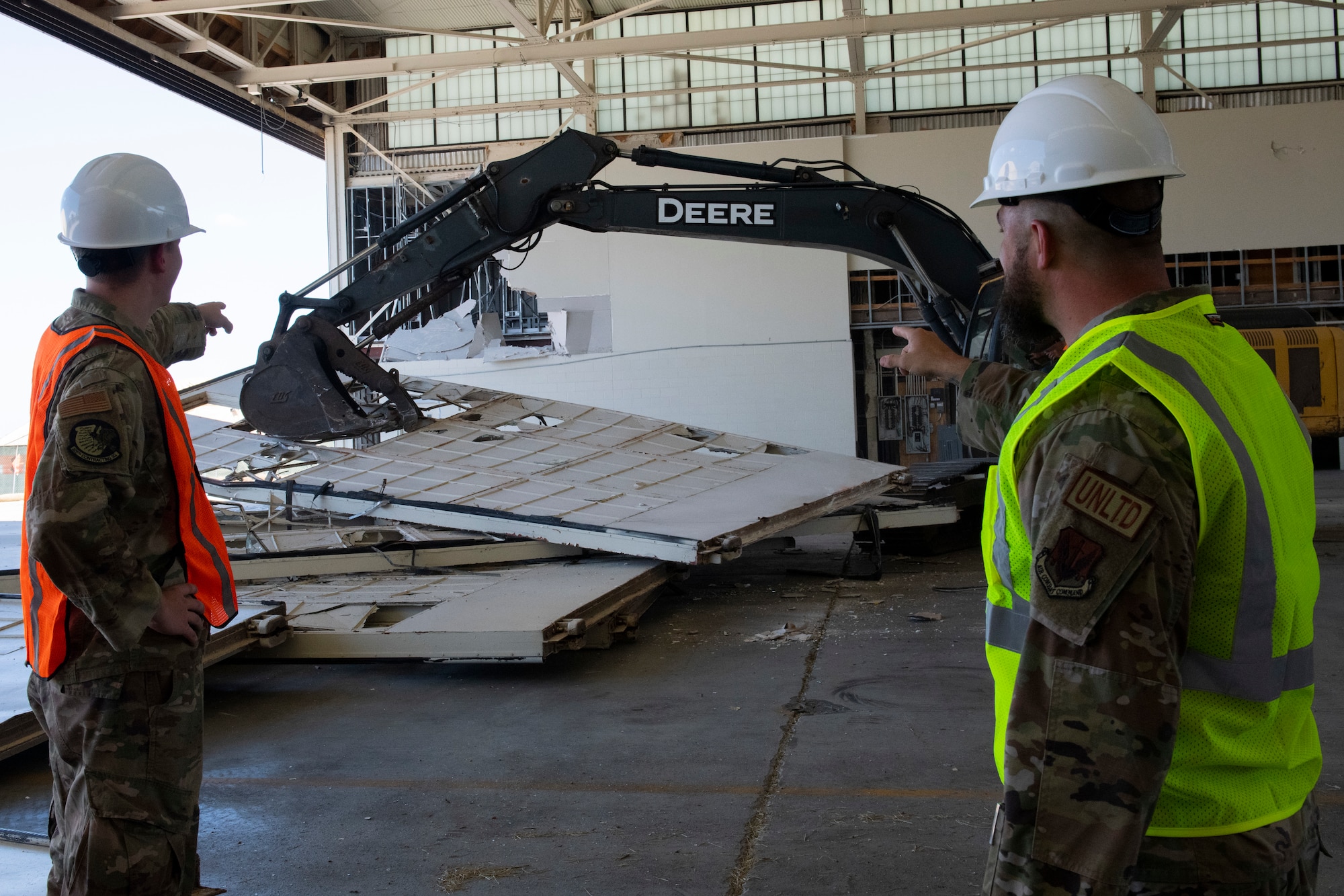 From left, U.S. Air Force Senior Airman Andrew Grant, 325th Contracting Squadron contract administrator, and Tech. Sgt. Clifford Roberts, 325th CONS contract officer, observe as the doors of Hangar 3 are removed at Tyndall Air Force Base, Florida, Sept. 20, 2022.