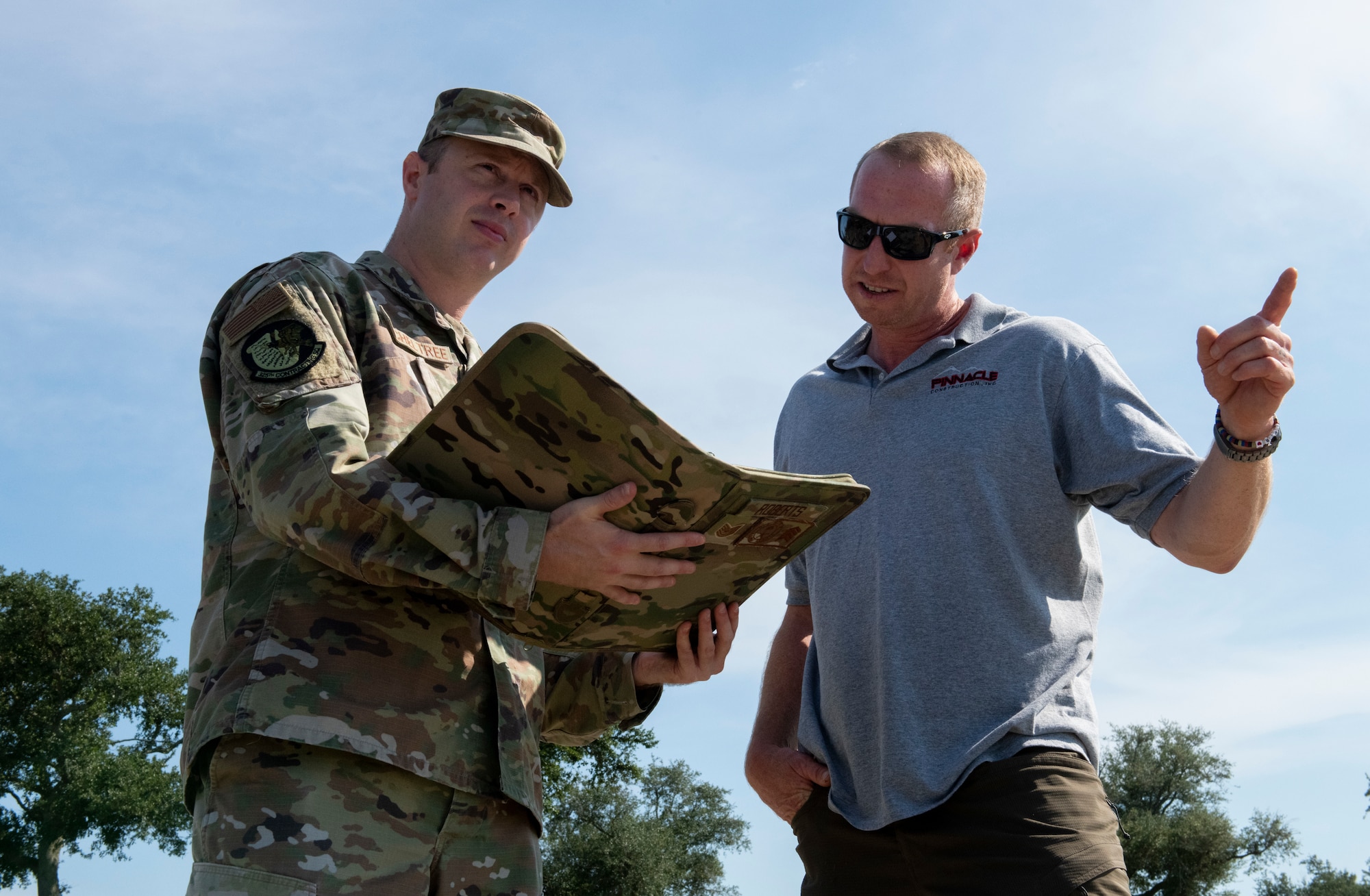 From left, U.S. Air Force Staff Sgt. Adam Mitcheltree, 325th Contracting Squadron contract specialist, and David Hagner, a contractor working with Tyndall Air Force Base, discuss restoration plans at Tyndall AFB, Florida, Sept. 13, 2022.