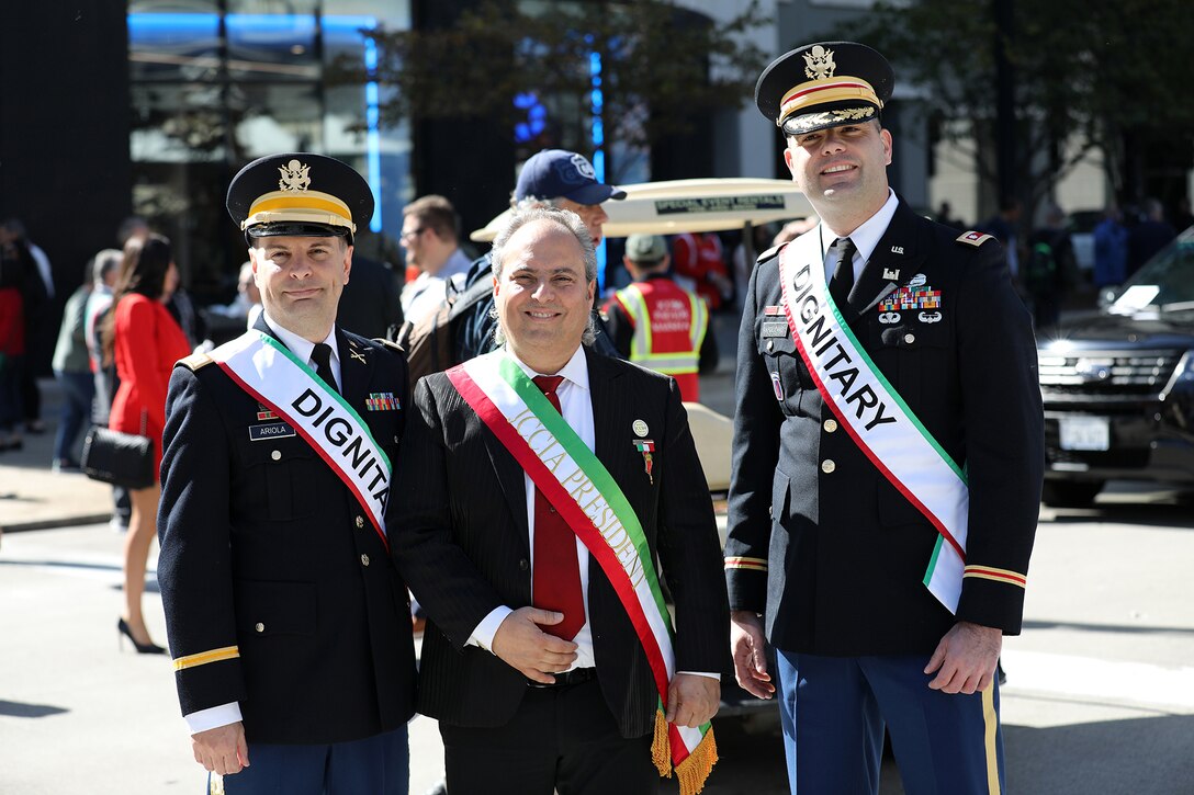 Capt. Michael Ariola, Public Affairs Officer (left), 85th U.S. Army Reserve Support Command, and Lt. Col. Arturo Napolitano, Commander, 318th Theater Public Affairs Support Element, pause for a photo with Ron Onesti, (center) President, Joint Civic Committee of Italian Americans, during the Chicago Columbus Day Parade, October 10, 2022.