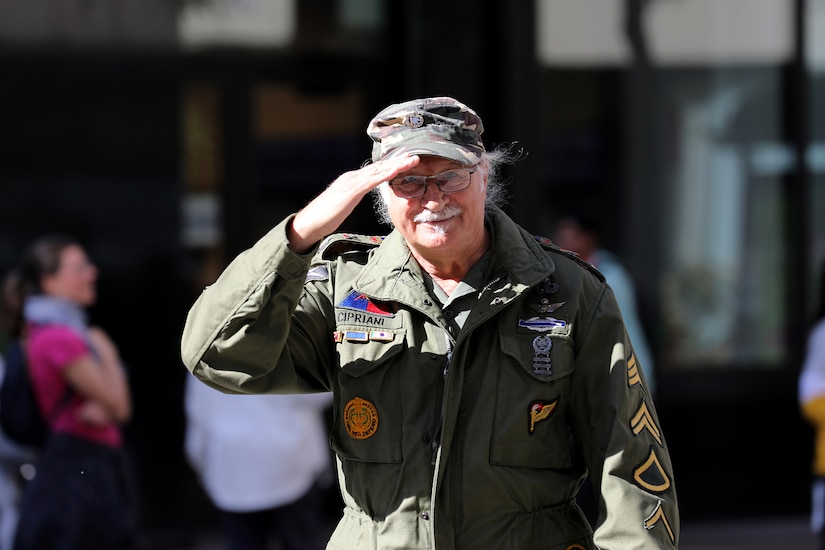 Flavio Cipriani, from North Riverside, Illinois, salutes spectators lining State Street during the 70th Annual Columbus Day Parade in Chicago, October 10, 2022.