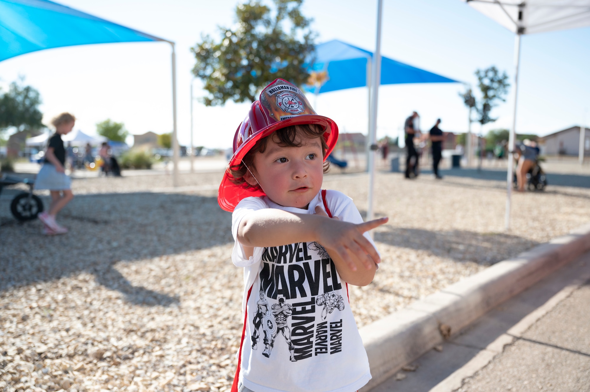 Avery, a Team Holloman child, poses for a photo at the National Night Out event at Holloman Air Force Base, New Mexico, Oct. 4, 2022. The event helps bring together the Alamogordo and base communities and provides a positive experience for Airmen and their families. (U.S. Air Force photo by Airman 1st Class Isaiah Pedrazzini)