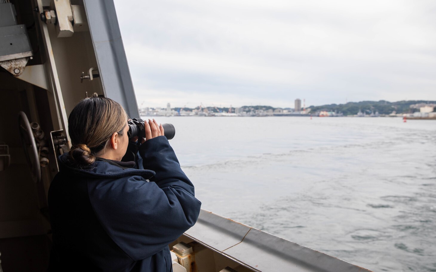 Gunner’s Mate 2nd Class Nancy Coronado, from Aguila, Arizona, stands watch as aft lookout aboard guided-missile destroyer USS Zumwalt (DDG 1000) while the ship departs getting underway from Commander, Fleet Activities Yokosuka, Oct. 8. Zumwalt is conducting underway operations in support of a free and open Indo-Pacific. (U.S. Navy photo by Mass Communication Specialist 2nd Class Jaimar Carson Bondurant)