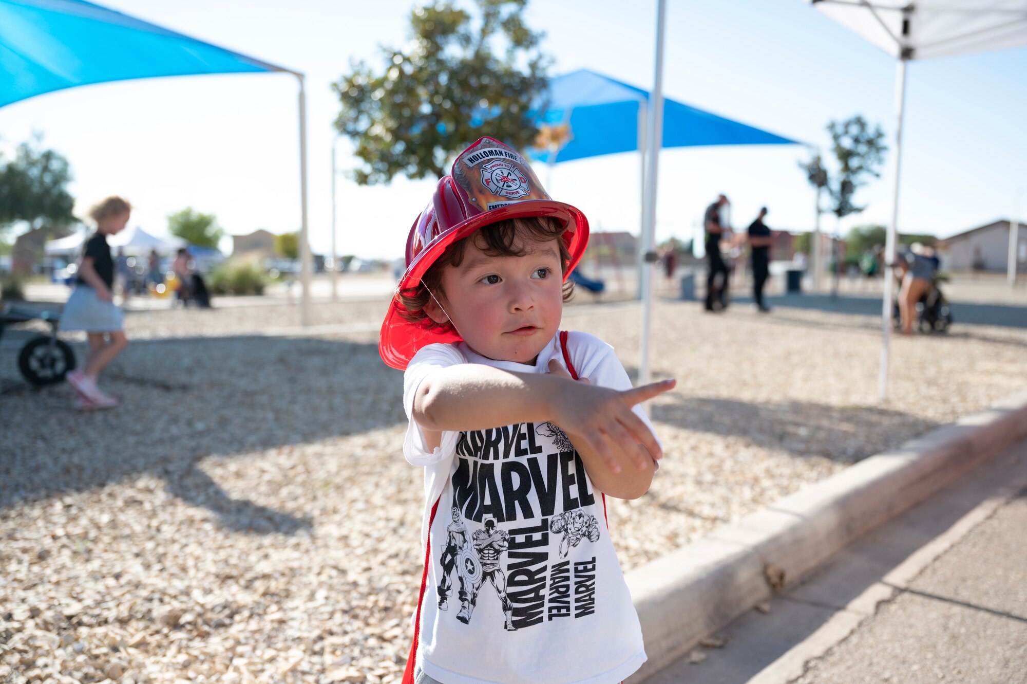 Avery, a Team Holloman child, poses for a photo at the National Night Out event at Holloman Air Force Base, New Mexico, Oct. 4, 2022. The event helps bring together the Alamogordo and base communities and provides a positive experience for Airmen and their families. (U.S. Air Force photo by Airman 1st Class Isaiah Pedrazzini)