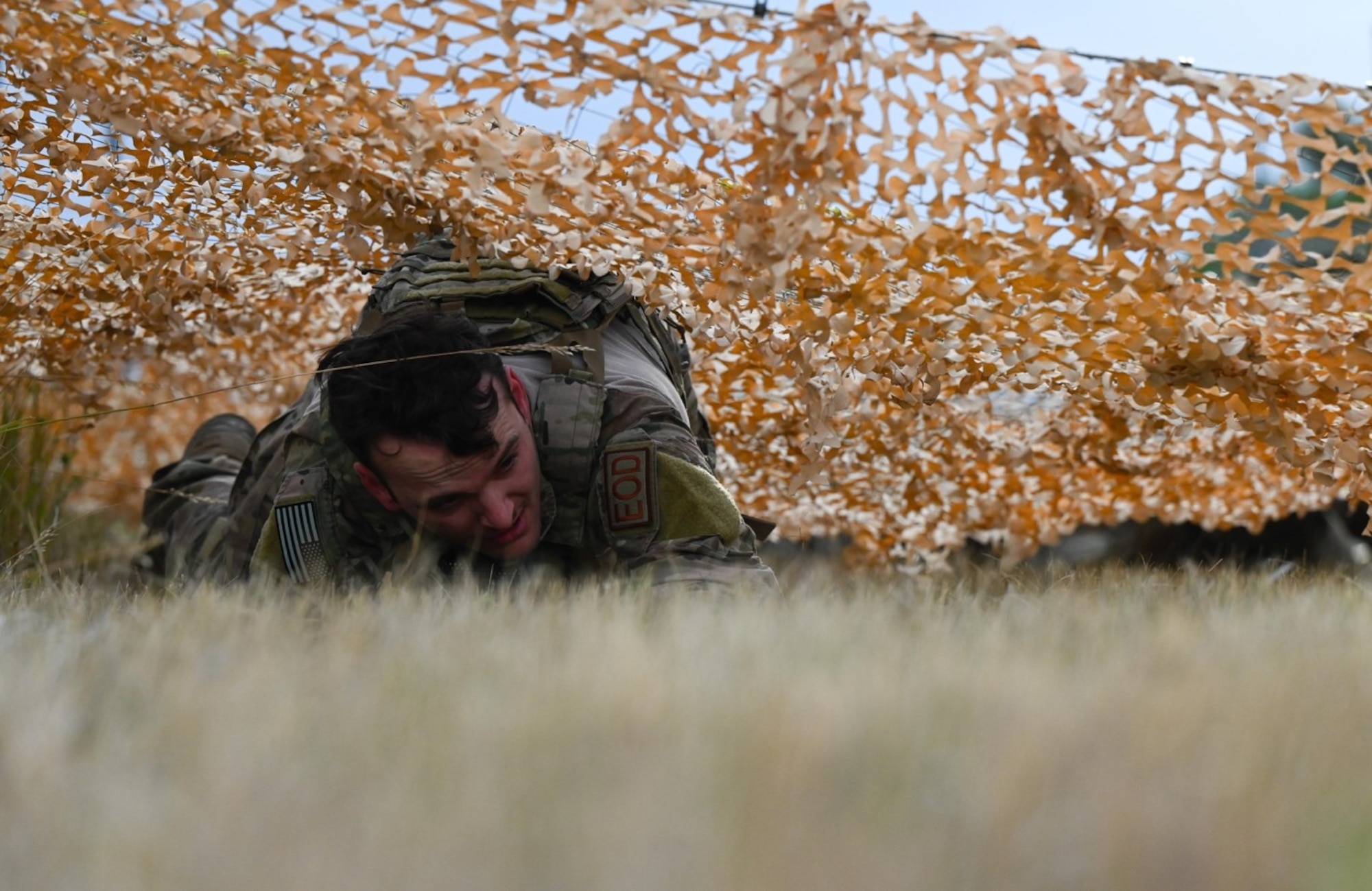 Staff Sgt. Dillon Willis, 28th Civil Engineer Squadron explosive ordnance disposal technician, performs a low crawl during the Prime Base Engineer Emergency Force Challenge at Ellsworth Air Force Base, S.D., Sept. 22, 2022.