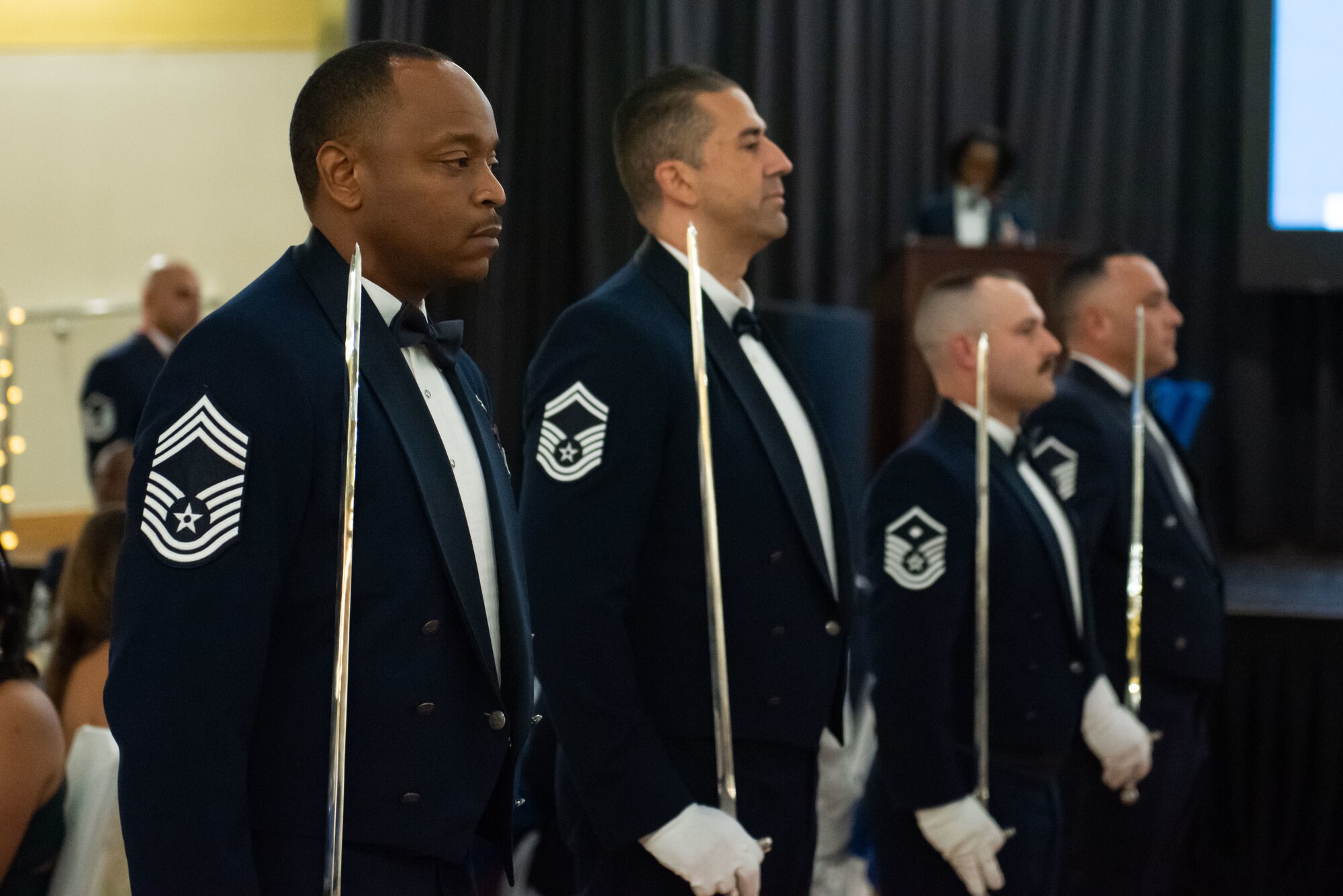 U.S. Air Force Airmen assigned to the 51st Fighter Wing stand at attention before forming a saber archway during a Senior Non-Commissioned Officer Induction Ceremony at Osan Air Base, Republic of Korea, Oct. 6, 2022.