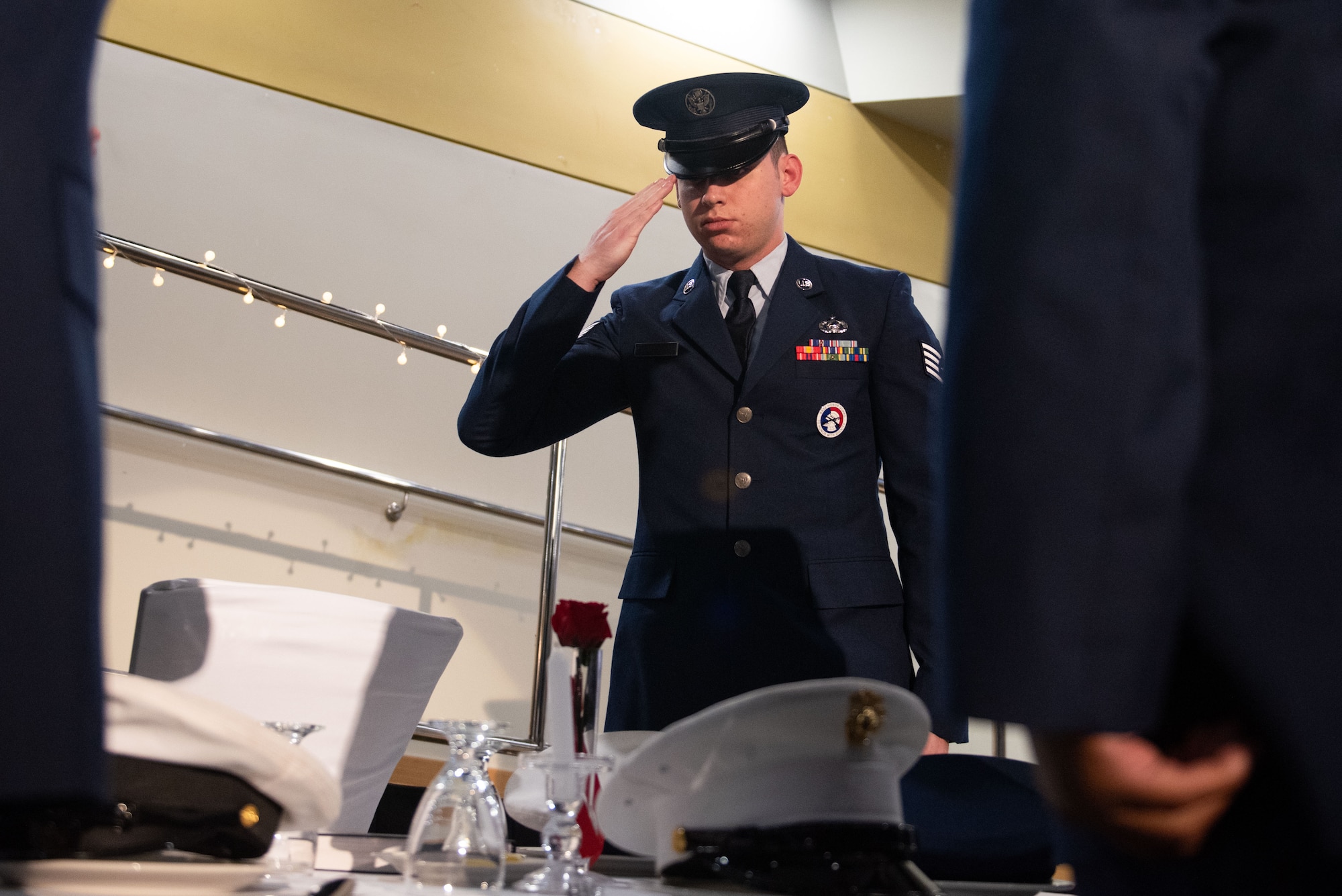 U.S. Air Force Staff Sgt. Chase Rakestraw, Osan Honor Guard member, renders a salute to the POW/MIA table during a Senior Non-Commissioned Officer Induction Ceremony at Osan Air Base, Republic of Korea, Oct. 6, 2022.