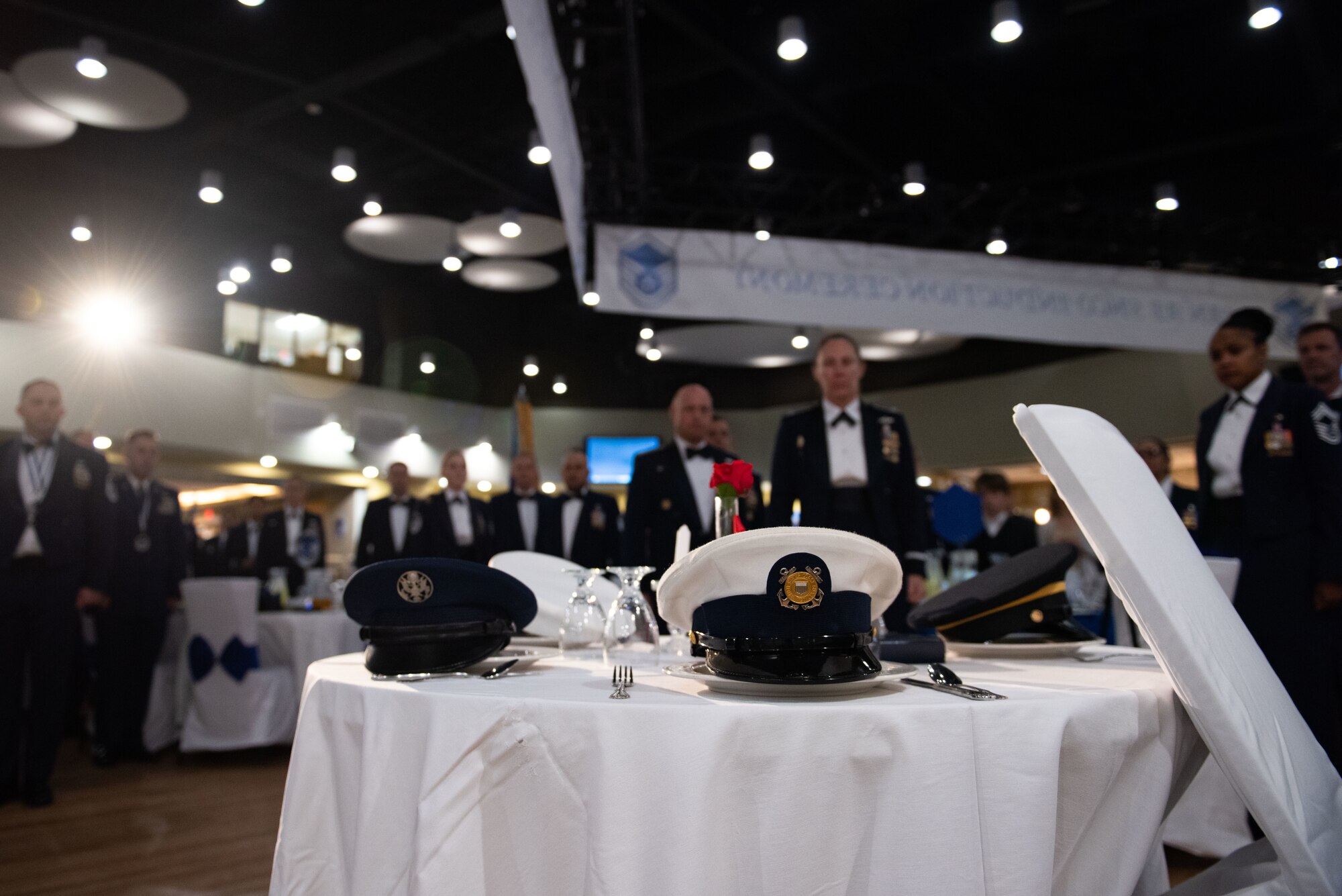 Attendees stand for a moment of silence in remembrance of those missing in action and prisoners of war during a Senior Non-Commissioned Officer Induction Ceremony at Osan Air Base, Republic of Korea, Oct. 6, 2022.