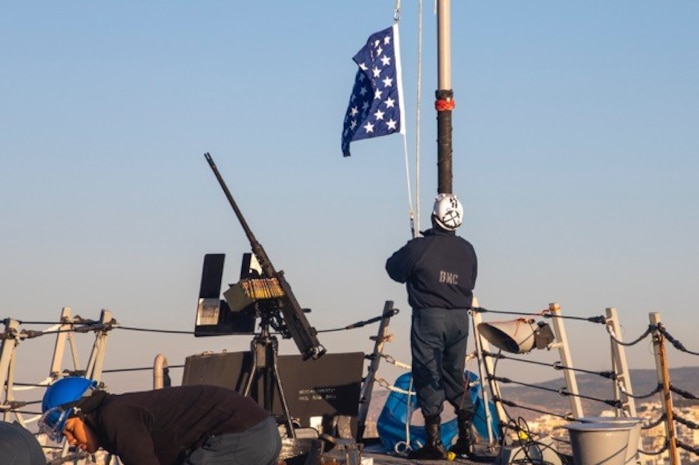 Chief Boatswain’s Mate Michael Davis, assigned to the Arleigh Burke-class guided-missile destroyer USS Farragut (DDG 99), raises the union jack on the ship’s bow, Oct. 10, 2022.