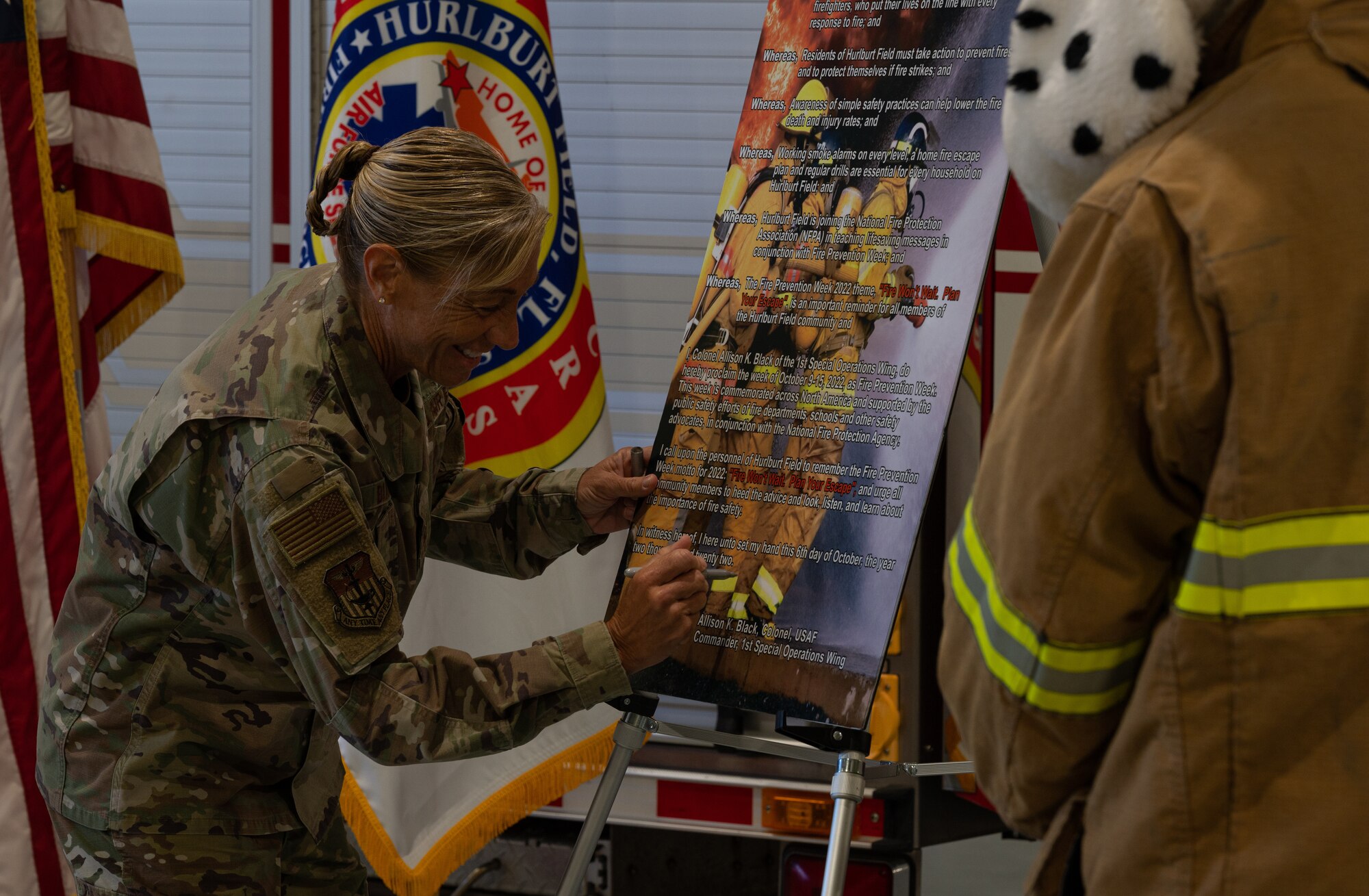 U.S. Air Force Col. Allison Black, 1st Special Operations Wing commander, signs the Fire Prevention Week Proclamation at Firehouse #1, Hurlburt Field, Florida, Oct. 6, 2022.