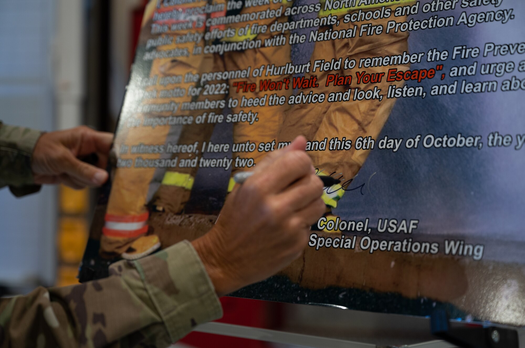 U.S. Air Force Col. Allison Black, 1st Special Operations Wing commander, signs a Fire Prevention Week Proclamation at Firehouse #1,Hurlburt Field, Florida, Oct. 6, 2022.