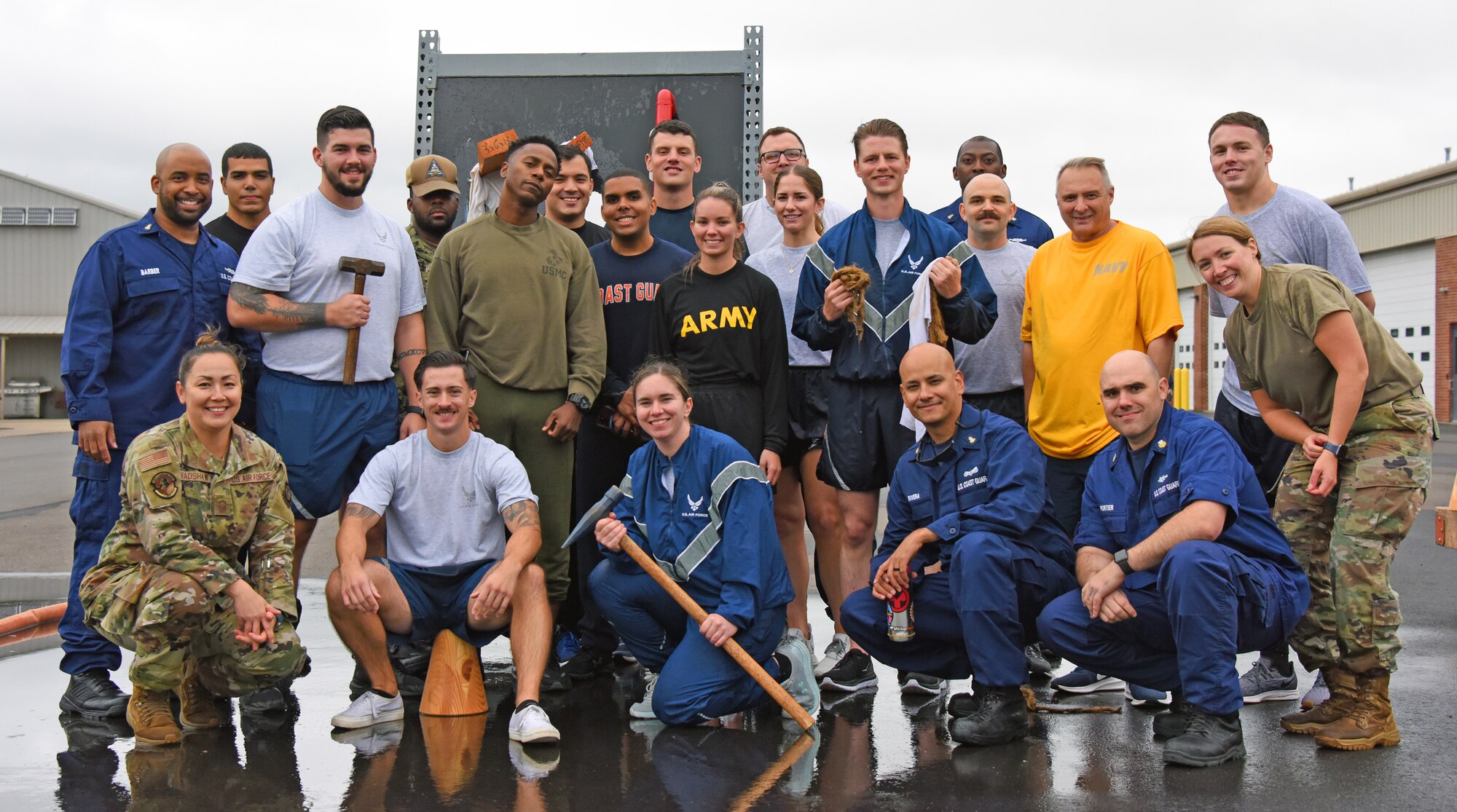 Students and class instructors pose for a picture after completing the damage control assessment.