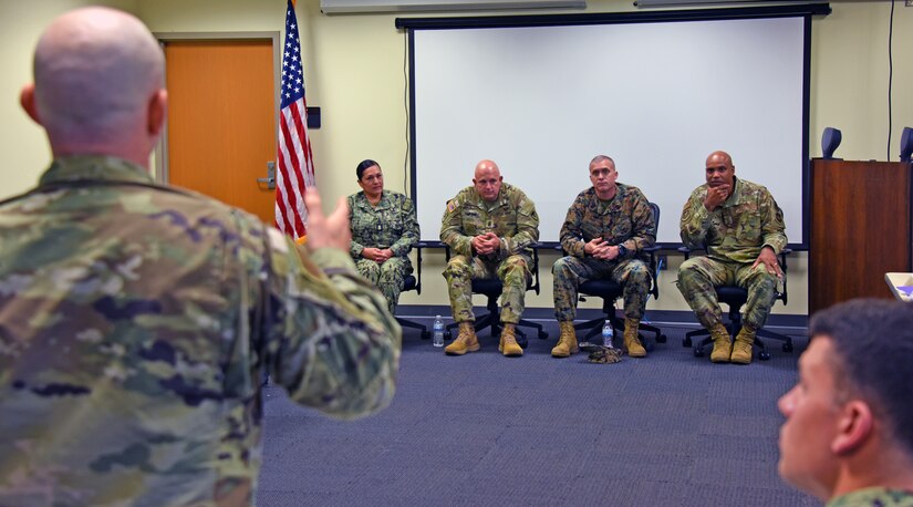 A student speaks to senior enlisted leadership in classroom.