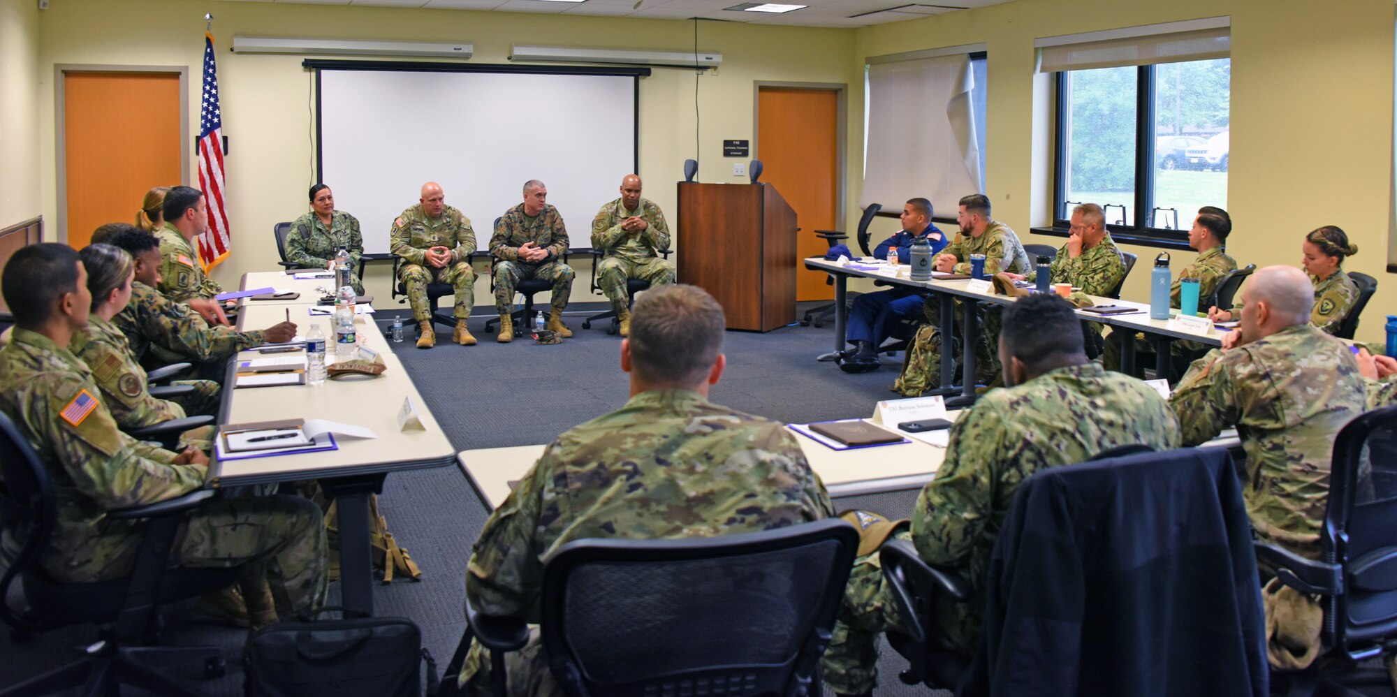 Senior enlisted leadership talks to students in classroom.