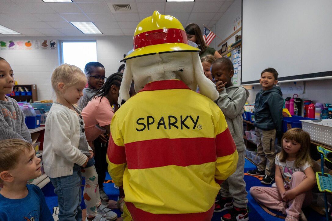 633d Civil Engineer Squadron firefighters from Joint base Langley-Eustis and Sparky the Fire Safety Dog visit Bethel Manor Elementary School as part of Fire Prevention Week.