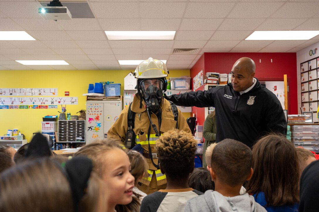 633d Civil Engineer Squadron firefighters from Joint base Langley-Eustis and Sparky the Fire Safety Dog visit Bethel Manor Elementary School as part of Fire Prevention Week.