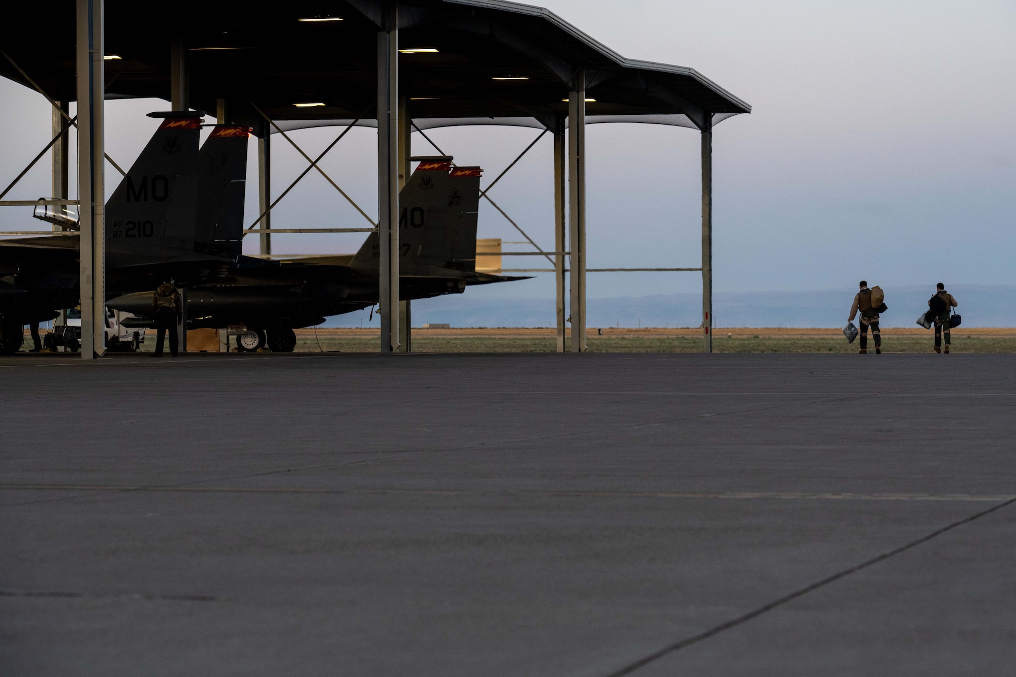 Airmen walk to an F-15E Strike Eagle