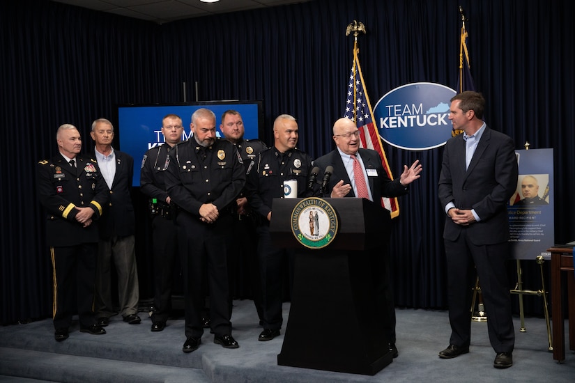 Kentucky Governor Andy Beshear (at podium) and Philip Miller, Kentucky chairman of the Employer Support of the Guard and Reserve(ESGR) presents the Secretary of Defense Freedom Award to Flemingsburg Police Chief Brian Bowling, at the Kentucky State Capitol in Frankfort, Ky. on Sept. 29, 2022. The Freedom Award is given to civilian employers of the Guard and Reserves by the ESGR for exceptional commitment to servicemembers' military careers. (U.S. Army photo by Andy Dickson)