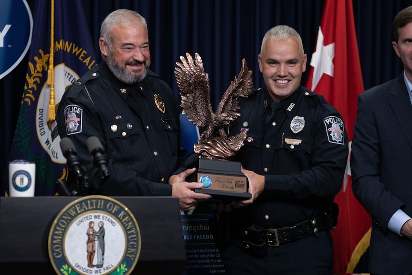 Flemingsburg Police Chief Brian Bowling (left) and Chief Warrant Officer Timothy Smith hold the Secretary of Defense Freedom Award at the Kentucky State Capitol in Frankfort, Ky. on Sept. 29, 2022. The Freedom Award is given to civilian employers of the Guard and Reserves by the ESGR for exceptional commitment to servicemembers' military careers. (U.S. Army photo by Andy Dickson)