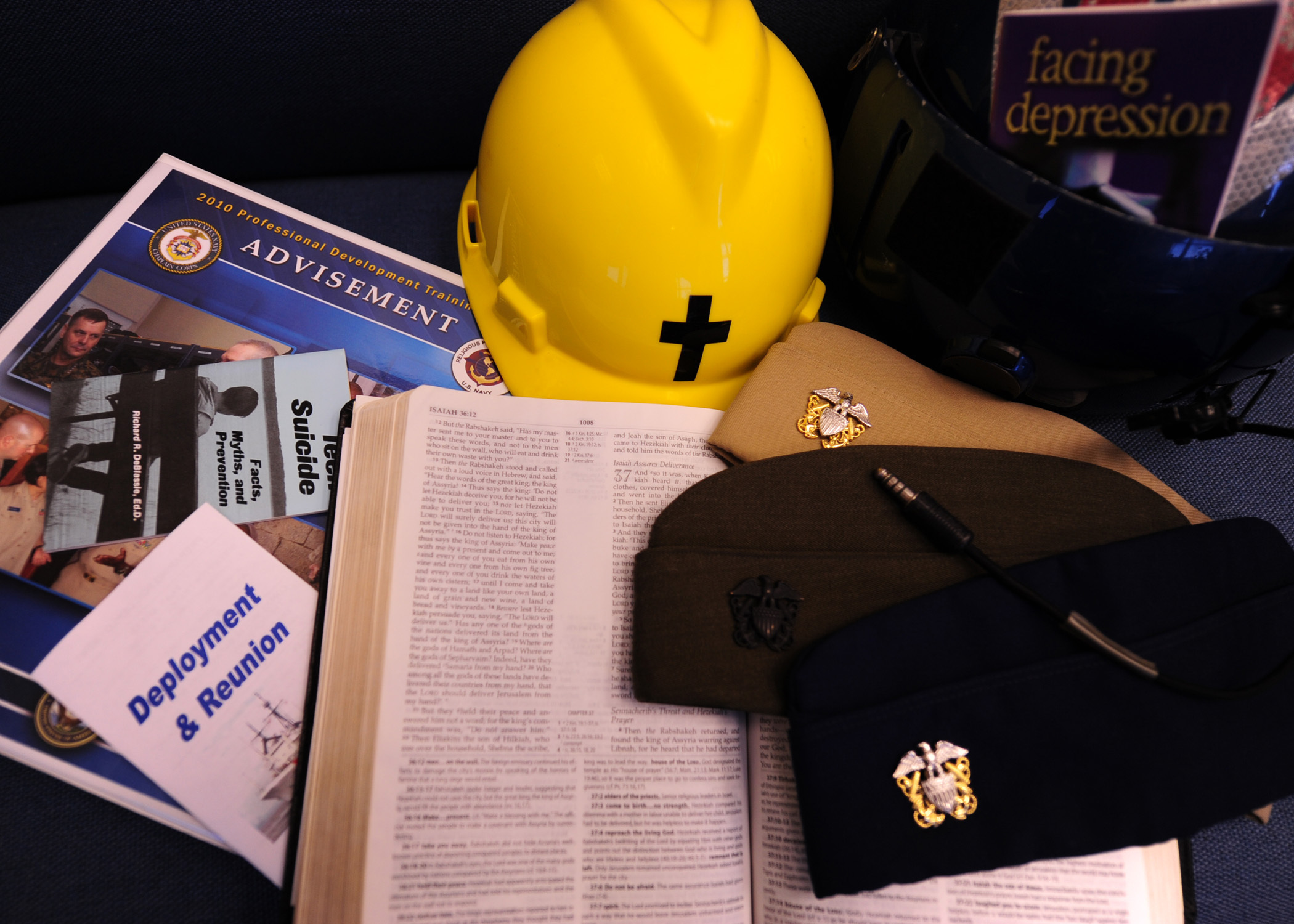 KODIAK, Alaska - Chaplains use tools such as bibles, pamphlets and guide books for command advisement. Chaplains wear multiple uniform hats throughout their careers, they can wear a Navy, Marine or Coast Guard uniform in the course of their careers. 

U.S. Coast Guard photo by Petty Officer 3rd Class Jonathan Lally.