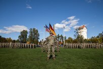 U.S. Army Maj. Todd Castles, executive officer of the 101st Airborne Division Sustainment Brigade, stands at parade rest at the helm of the unit during a ceremonial uncasing of their flag, streamers and colors following the unit’s arrival to the Grafenwöhr Training Area in Grafenwöhr, Germany, Oct. 6, 2022. After many years, the 101st Airborne Division once again joins the 1st Infantry Division in Europe to work alongside other NATO allies and regional security partners to provide combat-credible forces to V Corps, America's forward deployed corps. (U.S. Army photo by Spc. Charles Leitner)