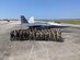 Group of Airmen stand in front of an F-22 Raptor.