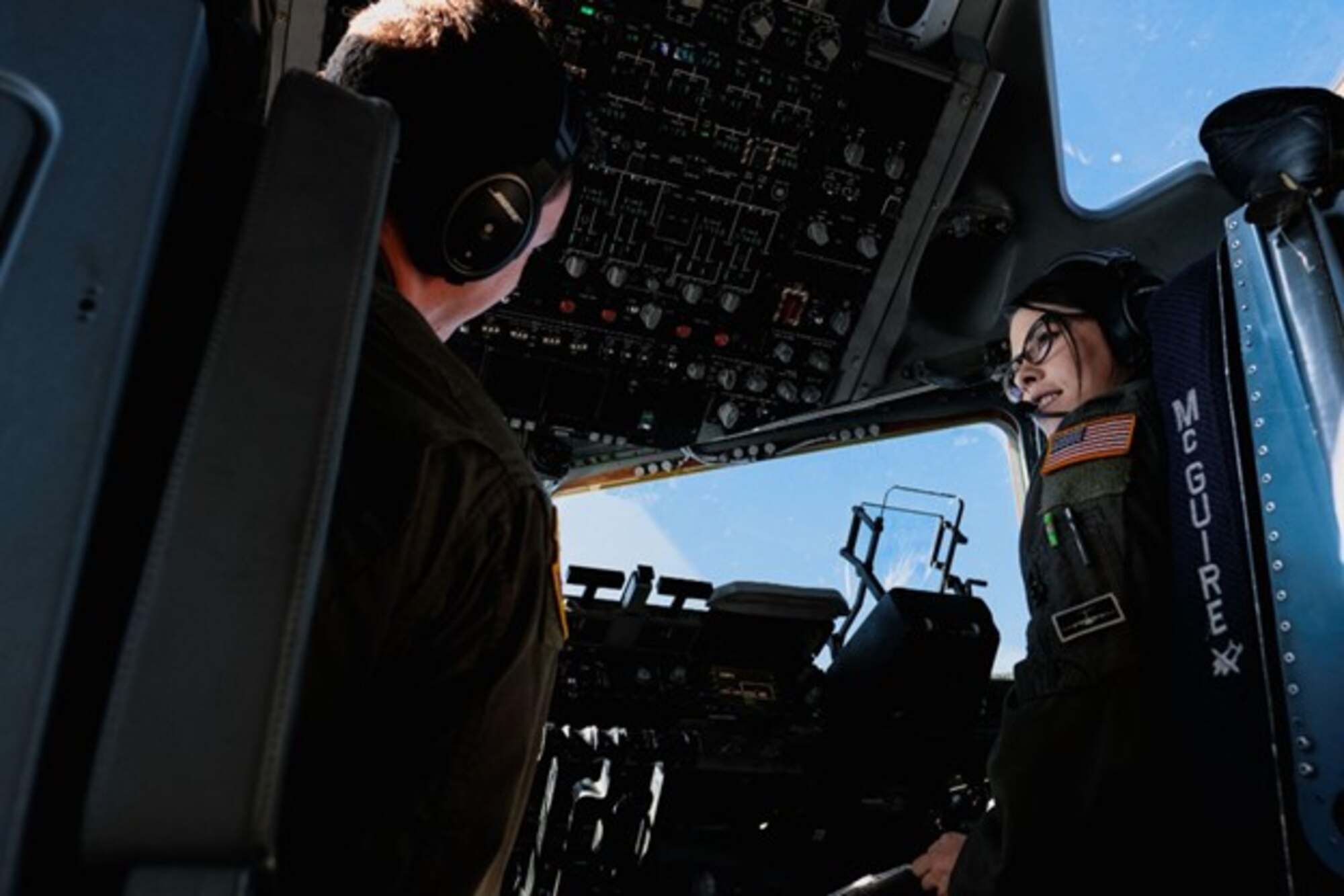 U.S. Air Force 1st Lt. Jenna Lazarus, 6th Airlift Squadron C-17 co-pilot, speaks to Capt. Max Alder, 6th Airlift Squadron C-17 pilot, during transit from Joint Base McGuire-Dix-Lakehurst, N.J., to Joint Base Langley-Eustis, V.A., Sept. 26, 2022.
