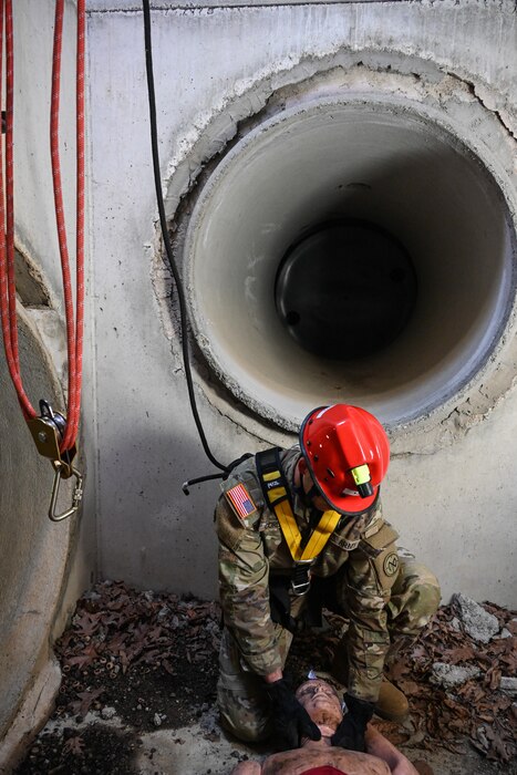 New York National Guard Pfc. Daniel Cordero is lowered into a manhole to rescue a casualty during a Homeland Response Force validation exercise at Fort Indiantown Gap, Pa., on September 10, 2022.
