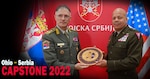 Maj. Gen. John C. Harris Jr., right, Ohio adjutant general, presents a carved medallion to Gen. Milan Mojsilović, chief of the Serbian Armed Forces General Staff, to commemorate the 15th anniversary of the State Partnership Program collaboration between Ohio and Serbia Sept. 8, 2022, in Belgrade, Serbia. The anniversary milestone was in 2021, but the COVID-19 pandemic prevented Harris from traveling to present the medallion until this year.
