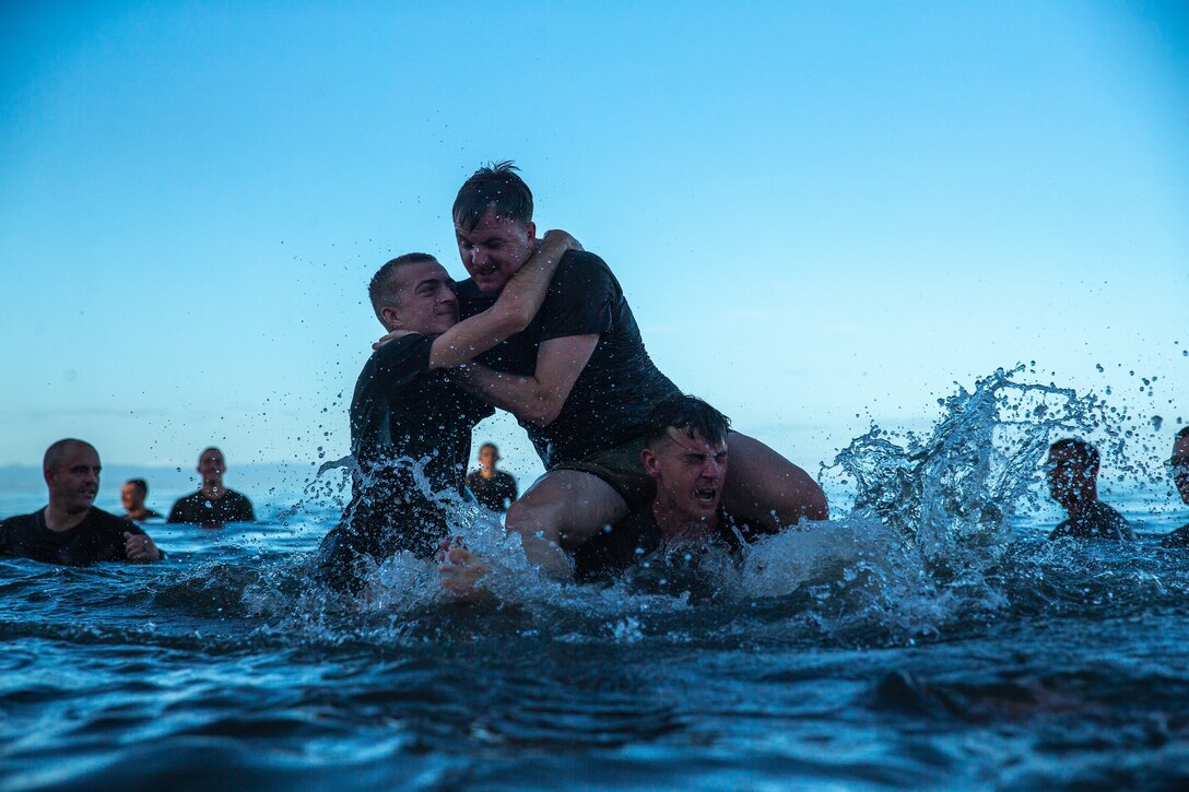 U.S. Marines with 1st Battalion, 2d Marines and Philippine Marines with Marine Battalion Landing Team 10 cool off after a unit physical training session during KAMANDAG 6, in San Vicente, Philippines, Oct. 8, 2022. KAMANDAG is an annual bilateral exercise between the Armed Forces of the Philippines and U.S. military, designed to strengthen interoperability, capabilities, trust, and cooperation built over decades of shared experiences. 1/2 is forward deployed under 4th Marines, 3d Marine Division as part of the Unit Deployment Program. (U.S. Marine Corps photo by Lance Cpl. Michael Taggart)