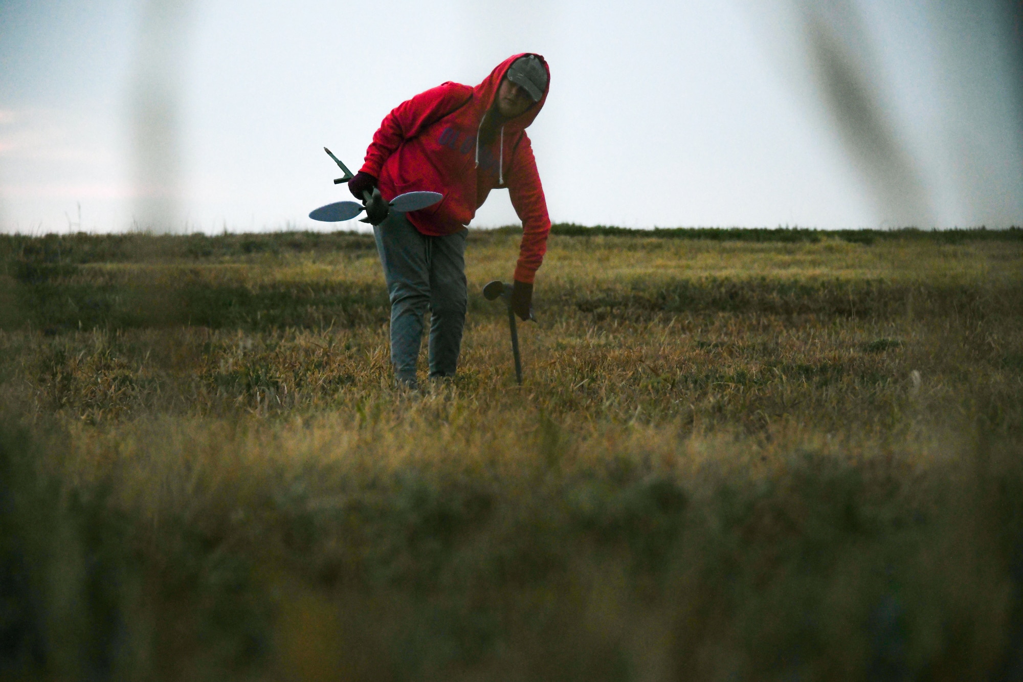 Evie Allen, daughter of U.S. Air Force Master Sgt. Nathan Allen, 97th Air Mobility Wing public affairs superintendent, picks up a decoy during a dove hunt at Altus Air Force Base, Oklahoma, Oct. 8, 2022. The base dove hunt helps to prevent the bird and wildlife aircraft strike hazard by reducing the number of birds on the airfield. (U.S. Air Force photo by Airman 1st Class Miyah Gray)