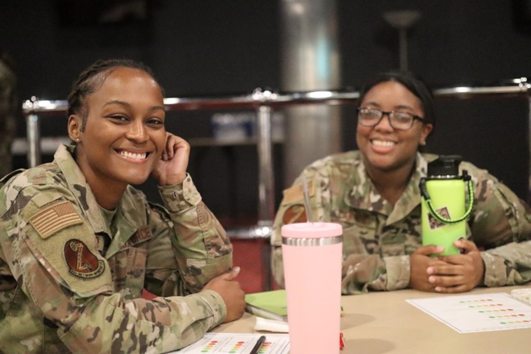 U.S. Air Force Senior Airman Paige Cesar (left) 83d Network Operations Squadron directory services operator and Senior Airman Kamisha Cannon, 83d Network Operations Squadron commander support staff technician smile for a photo during the Professional Enhancement Seminar at Joint Base Langley-Eustis, Virginia, Sept. 22, 2022.