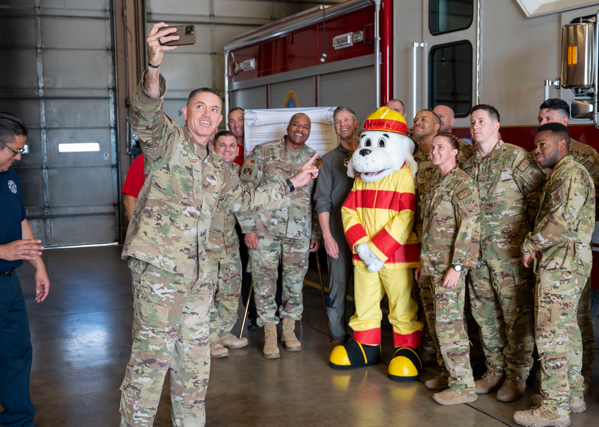 U.S. Air Force CMSgt. Jason Shaffer, 56th Fighter Wing command chief, takes a selfie with 56th Civil Engineer Squadron firefighters, Airmen and “Sparky” Oct. 7, 2022, at Luke Air Force Base, Arizona.