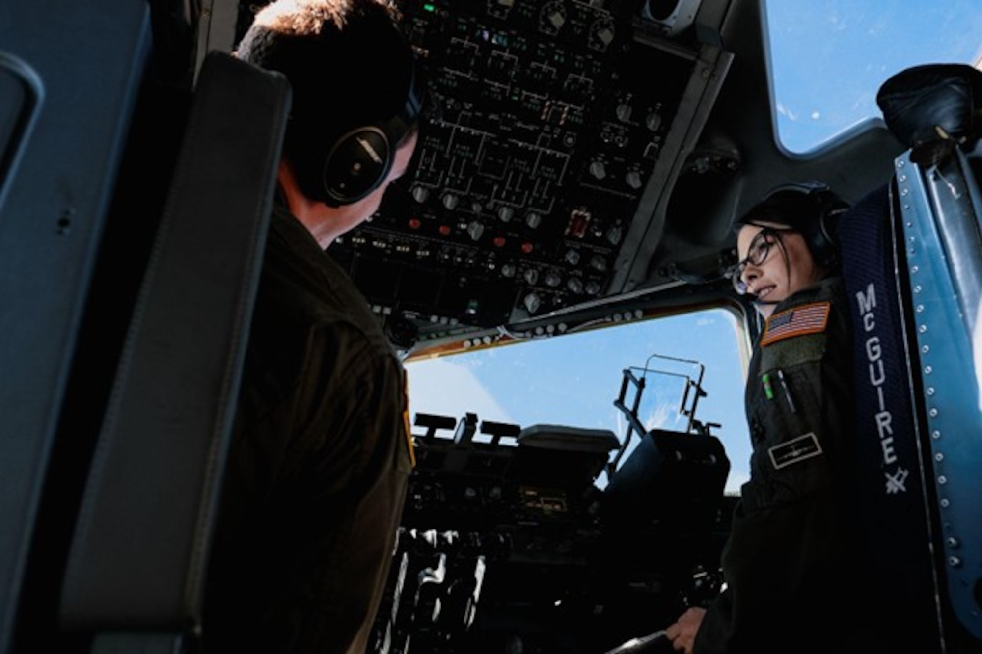 U.S. Air Force 1st Lt. Jenna Lazarus, 6th Airlift Squadron C-17 co-pilot, speaks to Capt. Max Alder, 6th Airlift Squadron C-17 pilot, during transit from Joint Base McGuire-Dix-Lakehurst, N.J., to Joint Base Langley-Eustis, V.A., Sept. 26, 2022.