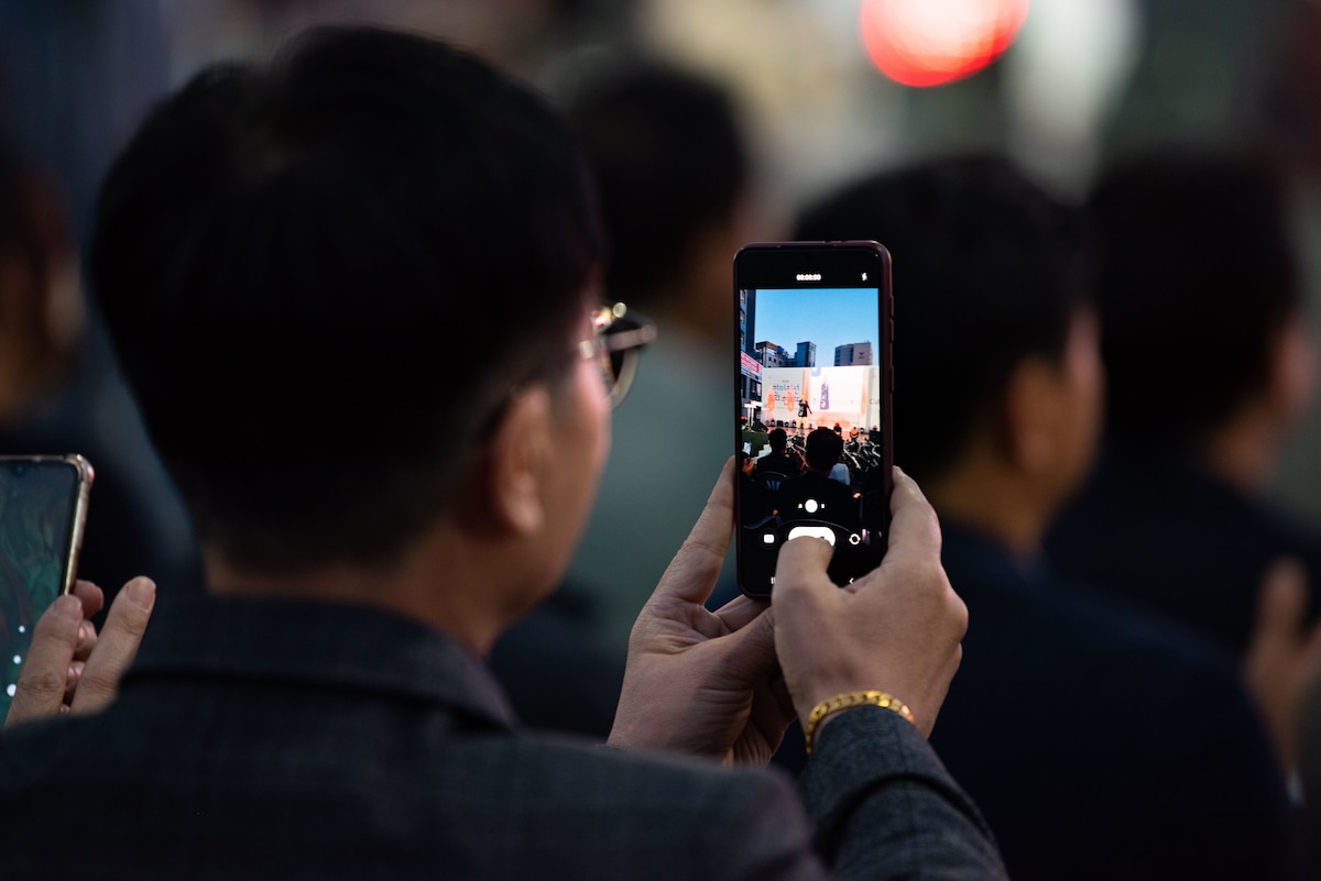 An attendee records a performance by singer So Chan-whee during the 19th Republic of Korea and the United States Cultural Festival, in front of Osan Air Base, Republic of Korea, Oct. 8, 2022.