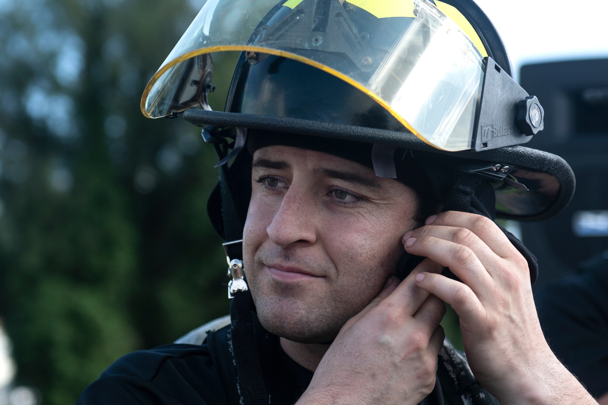 Tech Sgt. Tyler Gasper, 718th Aircraft Maintenance Squadron hydraulics craftsman, secures his helmet at the fire muster challenge during National Fire Prevention Week at Kadena Air Base, Japan, Oct. 6, 2022. Fire Prevention Week is held annually to raise awareness on fire prevention measures and emergency procedures throughout the community. (U.S. Air Force photo by Senior Airman Jessi Roth)