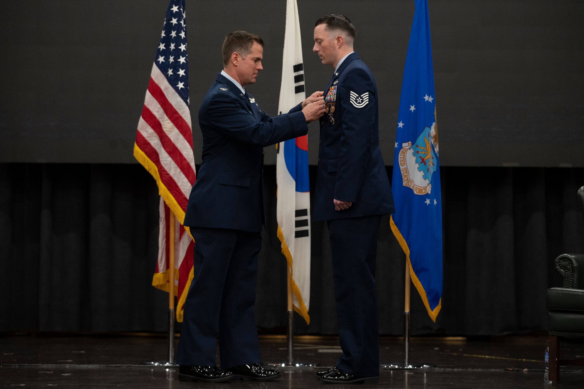 U.S. Air Force Col. Joshua Wood, 51st Fighter Wing commander, presents U.S. Air Force Tech. Sgt. Jordan Locke, 51st Security Forces Squadron flight sergeant, the Bronze Star with Valor during a presentation ceremony at Osan Air Base, Republic of Korea, Oct. 12, 2022.