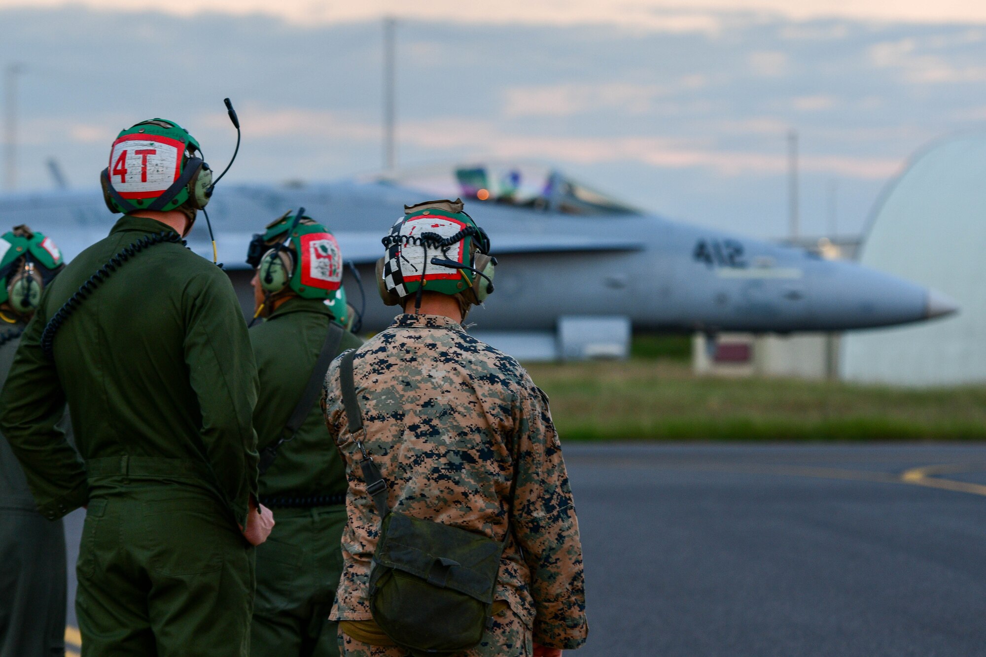 U.S. Marines watch as an F/A-18 Hornet assigned to the Marine Fighter Attack Squadron 323 based out of Marine Corps Air Station Miramar, California, taxis for takeoff at Aviano Air Base, Italy, Sept. 20, 2022. More than 200 U.S. Marines were deployed to Aviano AB for approximately two months to integrate and train with the 510th Fighter Squadron as part of a dynamic force employment. (U.S. Air Force photo by Senior Airman Brooke Moeder)