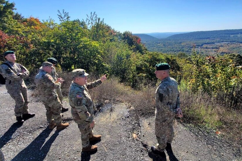 Command Sgt. Maj. Jon Worley, second from right, senior enlisted leader, Pennsylvania National Guard, points out a feature of Fort Indiantown Gap's training area to Command Sgt. Maj. Darius Masiulis, far right, Lithuanian Land Forces command sergeant major, on Oct. 9, 2022. Masiulis, along with Brig. Gen. Arturas Radvilas, Lithuanian Land Forces commander, and Brig. Gen. Modestas Petrauskas, Lithuanian defense attaché to the United States and Canada, visited Fort Indiantown Gap and attended the 28th Infantry Division departure ceremony in Harrisburg on Oct. 9.