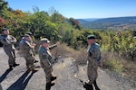 Command Sgt. Maj. Jon Worley, second from right, senior enlisted leader, Pennsylvania National Guard, points out a feature of Fort Indiantown Gap's training area to Command Sgt. Maj. Darius Masiulis, far right, Lithuanian Land Forces command sergeant major, Oct. 9, 2022. Masiulis and Brig. Gen. Arturas Radvilas, Lithuanian Land Forces commander, and Brig. Gen. Modestas Petrauskas, Lithuanian defense attaché to the United States and Canada, visited Fort Indiantown Gap and attended the 28th Infantry Division departure ceremony in Harrisburg.