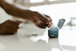 Woman places pills in pill box