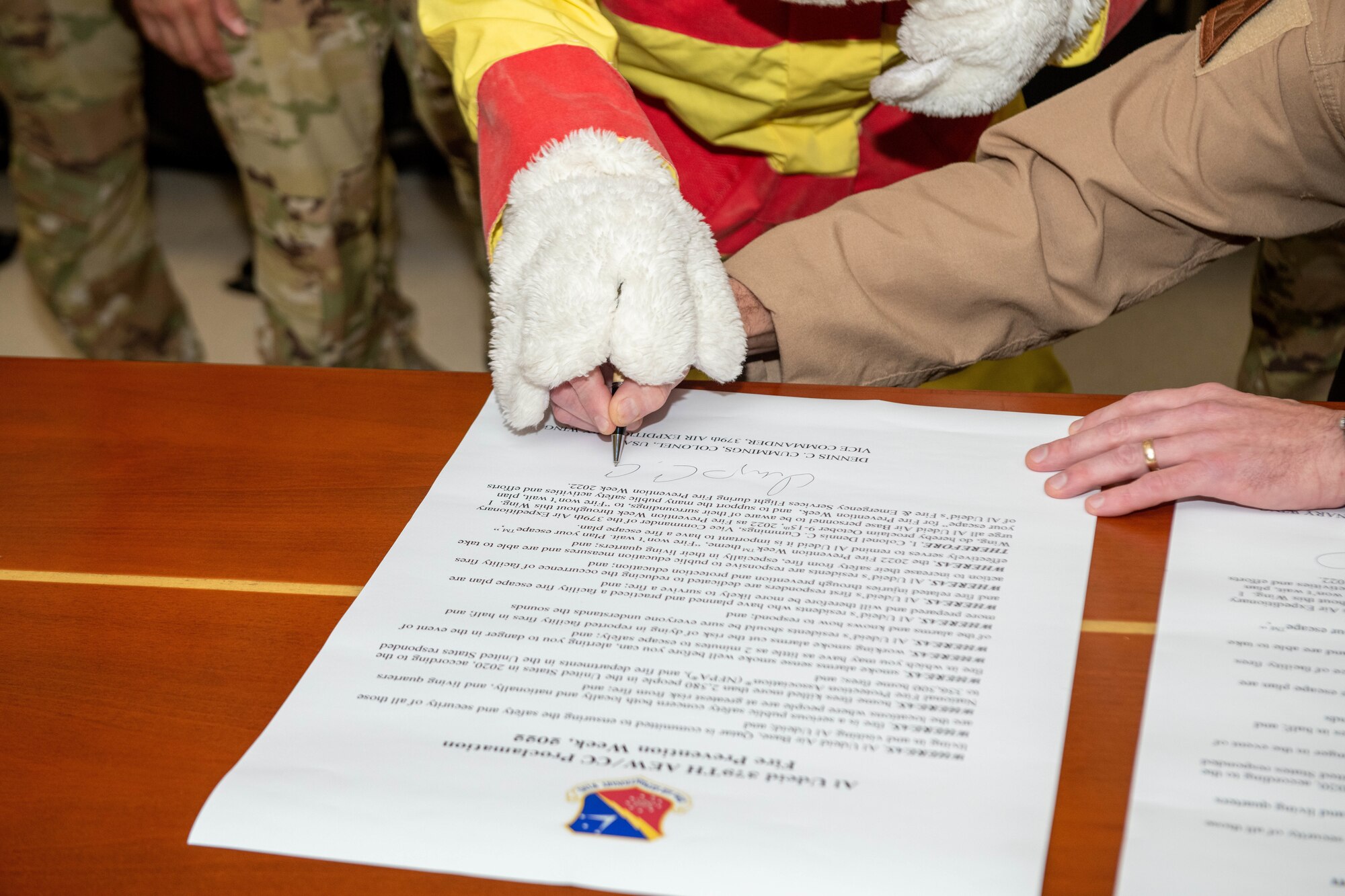 U.S. Air Force Col. Dennis Cummings, 379th Air Expeditionary Wing deputy commander, signs a fire proclamation on Al Udeid Air Base, Qatar, Sept. 30, 2022. During Fire Prevention Week, firefighters with the 379th Expeditionary Civil Engineer Squadron will hold activities focused on fire prevention and awareness. (U.S. Air National Guard photo by Airman 1st Class Constantine Bambakidis)