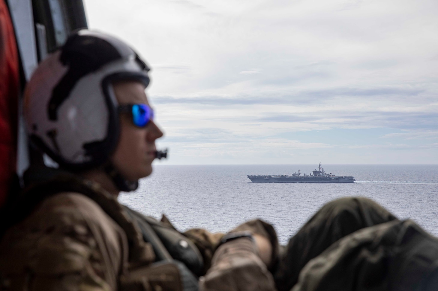 Naval Aircrewman (Helicopter) 2nd Class Brian Sedin watches as the Nimitz-class aircraft carrier USS George H.W. Bush (CVN 77), sails alongside the supply-class fast combat support ship USNS Arctic (T-AOE 8) during a replenishment-at-sea, Sept. 29, 2022. Carrier Air Wing (CVW) 7 is the offensive air and strike component of Carrier Strike Group (CSG) 10 and the George H.W. Bush Carrier Strike Group (GHWBCSG). The squadrons of CVW-7 are Strike Fighter Squadron (VFA) 143, VFA-103, VFO-86, VFA-136, Electronic Attack Squadron (VAQ) 140, VAW-121, HSC-5, and Helicopter Maritime Strike Squadron (HSM) 46. The GHWBCSG is on a scheduled deployment in the U.S. Naval Forces Europe area of operations, employed by U.S. Sixth Fleet to defend U.S., allied and partner interests.