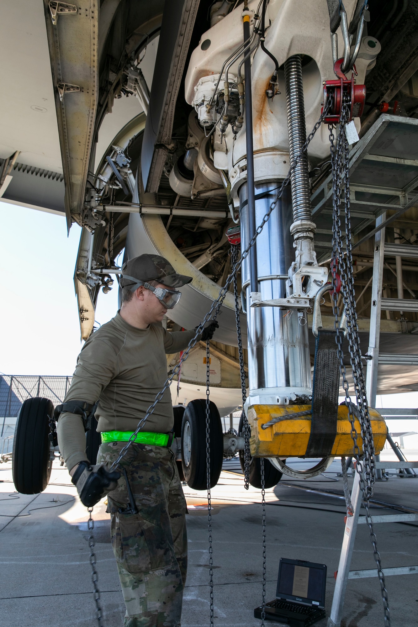 Senior Airman Andrew Small, 436th Aircraft Maintenance Squadron hydraulic systems journeyman, lowers the number three main landing gear strut assembly to perform maintenance on a C-5M Super Galaxy at Dover Air Force Base, Delaware, Oct. 6, 2022. Small and other hydraulic system maintainers replaced internal seals on the strut during a repack procedure. (U.S. Air Force photo by Roland Balik)