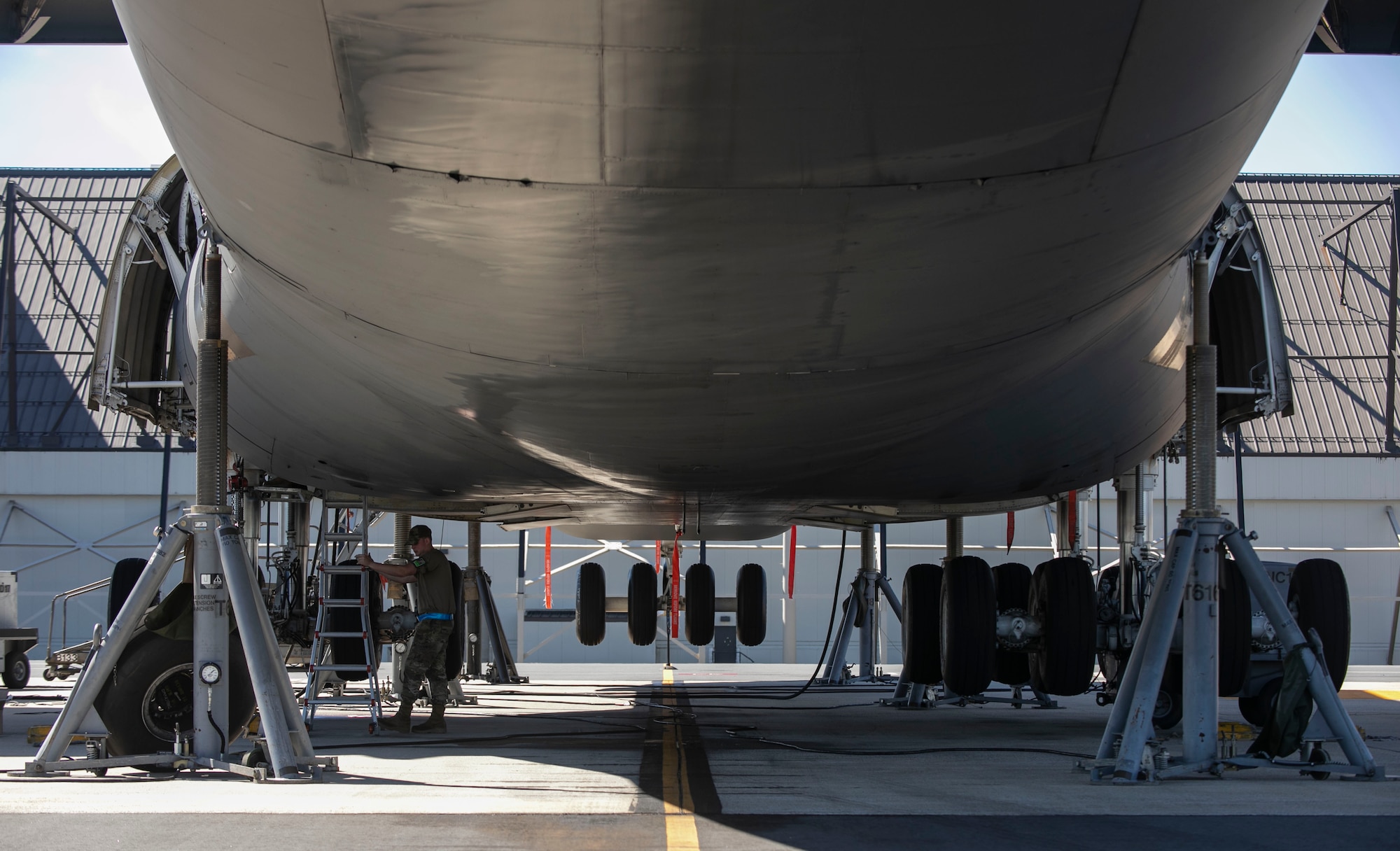 A C-5M Super Galaxy sits on jacks during a number three main landing gear strut repack at Dover Air Force Base, Delaware, Oct. 6, 2022. Hydraulic system maintainers assigned to the 436th Aircraft Maintenance Squadron removed and replaced internal seals as part of the repack procedure. (U.S. Air Force photo by Roland Balik)