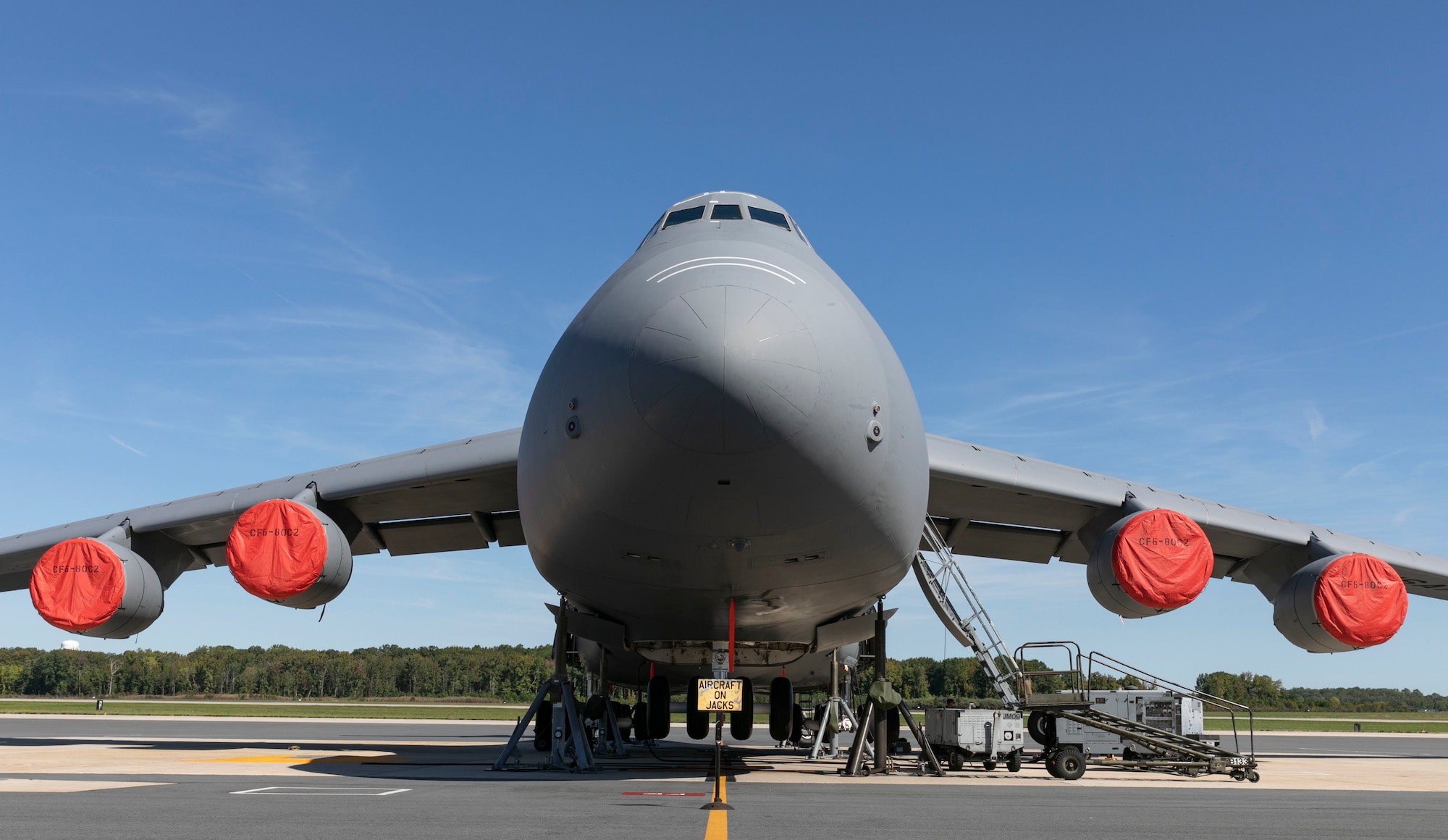 A C-5M Super Galaxy sits on jacks during a number three main landing gear strut repack at Dover Air Force Base, Delaware, Oct. 6, 2022. Hydraulic system maintainers assigned to the 436th Aircraft Maintenance Squadron removed and replaced internal seals as part of the repack procedure. (U.S. Air Force photo by Roland Balik)